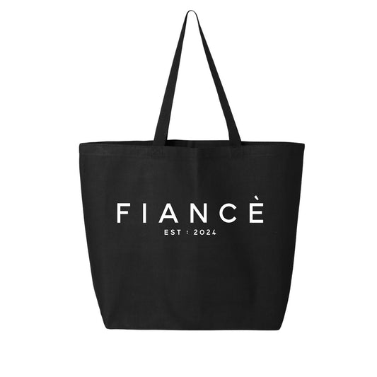 A stylish and practical accessory for your everyday needs, the Fiancé Tote Bag from Badd Boss features two handles and is crafted from lightweight material. The design includes the word "FIANCÉ" prominently displayed in large white letters in the center, with "EST: 2024" written in smaller white letters below.